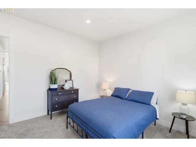 a bedroom with a bed and a dresser