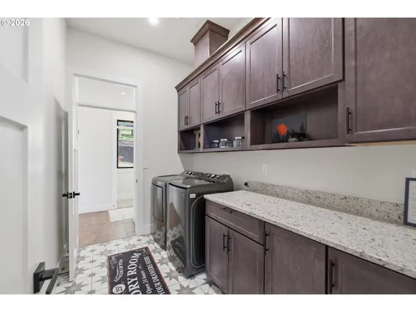 a kitchen with stainless steel appliances granite countertop a sink a stove a refrigerator and cabinets