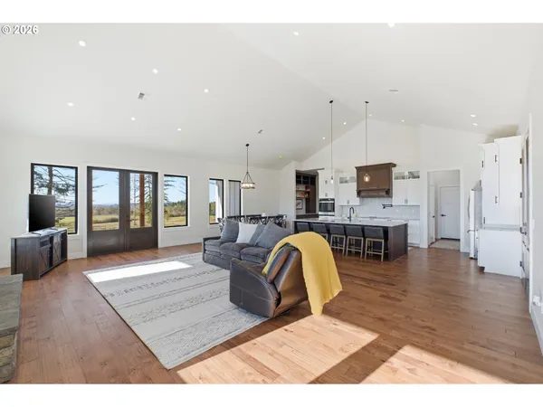 a living room with furniture and kitchen view