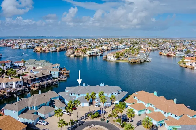 a living room with furniture a flat screen tv and a table