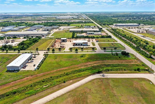 an aerial view of a pool with a yard