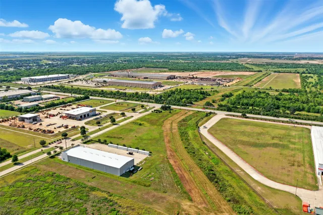 an aerial view of residential houses with outdoor space and swimming pool