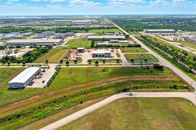 an aerial view of a pool with a yard