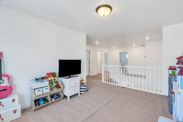 646 South Meade Street Mapleton, UT 84664 - Photo 16 of 46 Spacious upper-level landing featuring neutral carpeting, white wall finishes, and a white balustrade overlooking the level below