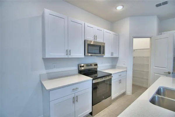 a kitchen with a sink and cabinets