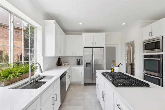 a kitchen with a sink stove and refrigerator