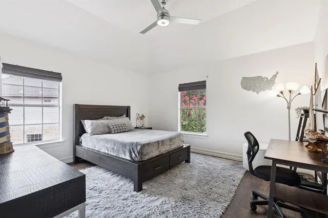 a bedroom with a bed a desk and chair