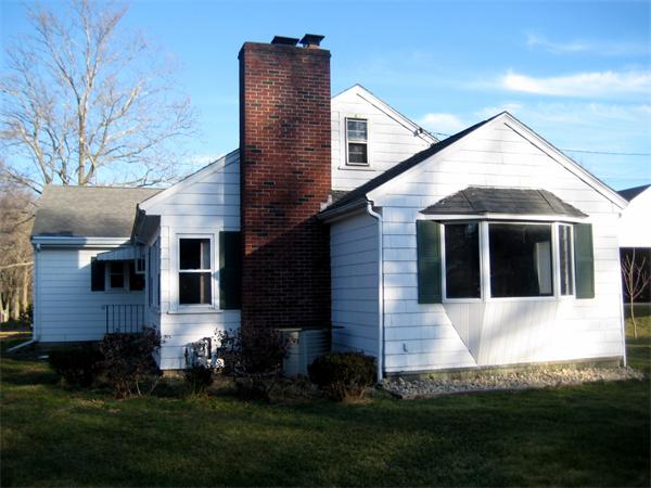 7 Pilgrim Way Walpole, MA 02032 - Photo 16 of 17 a front view of a house with a yard and trees