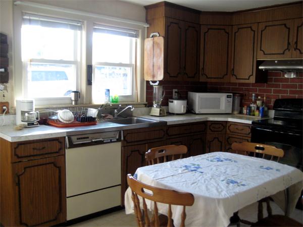 7 Pilgrim Way Walpole, MA 02032 - Photo 2 of 17 a kitchen with a stove a sink a microwave and wooden cabinets