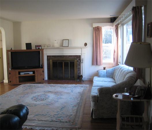 7 Pilgrim Way Walpole, MA 02032 - Photo 5 of 17 a living room with furniture a flat screen tv and a fireplace