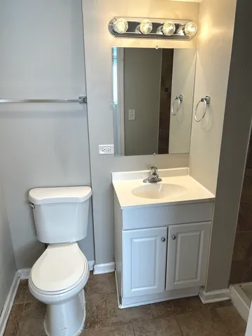 a bathroom with a sink toilet and mirror