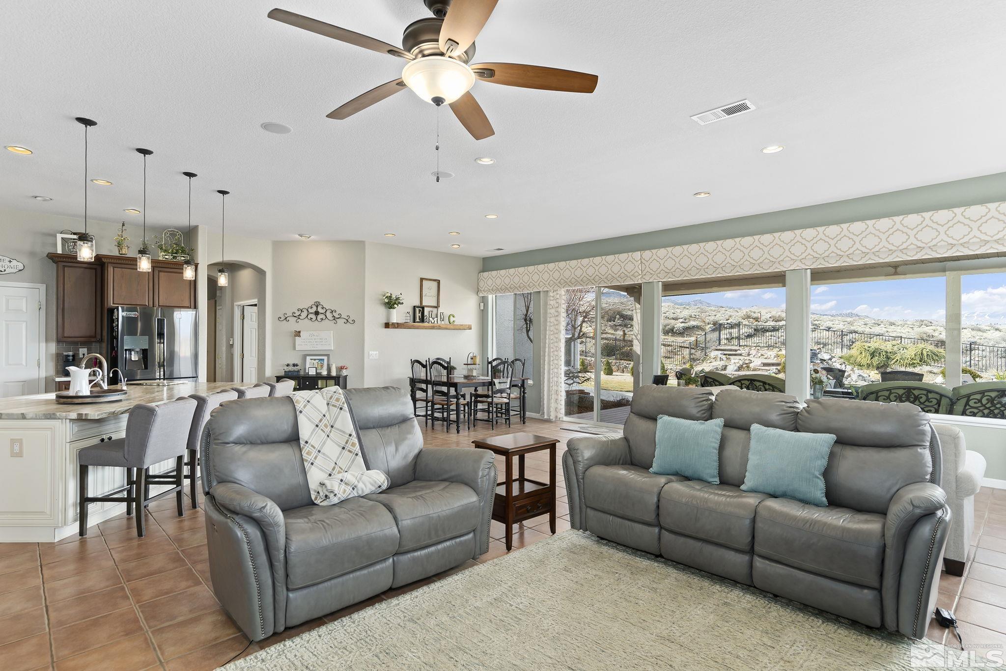 2095 North Tesuque Road Reno, NV 89511 - Photo 12 of 40 a living room with furniture ceiling fan and a large window