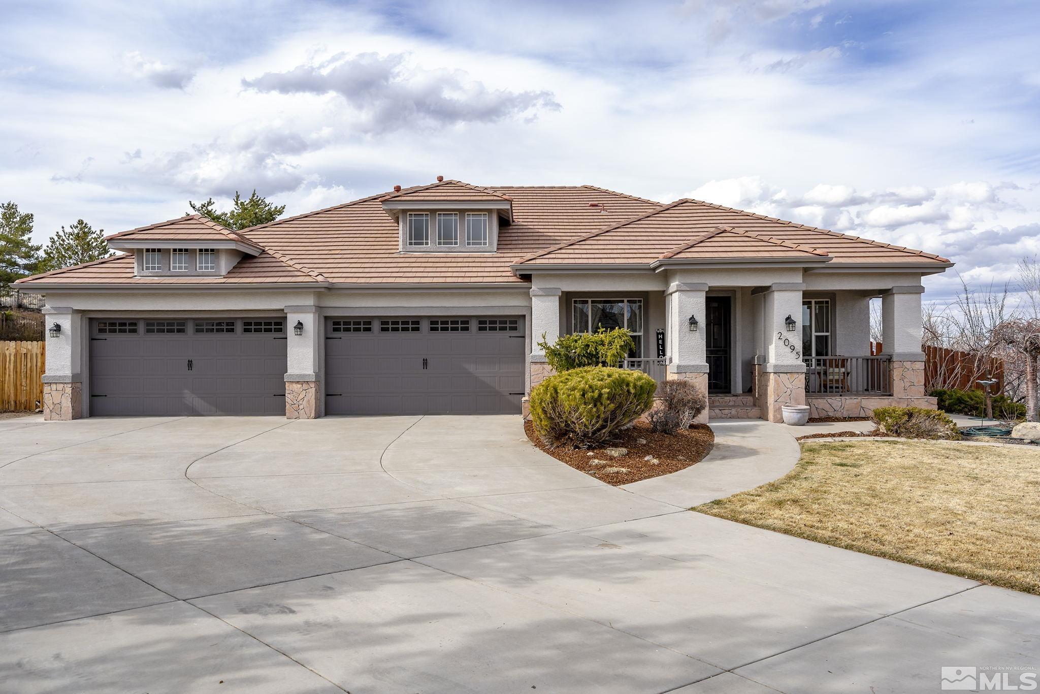 2095 North Tesuque Road Reno, NV 89511 - Photo 4 of 40 a front view of a house with table and chairs