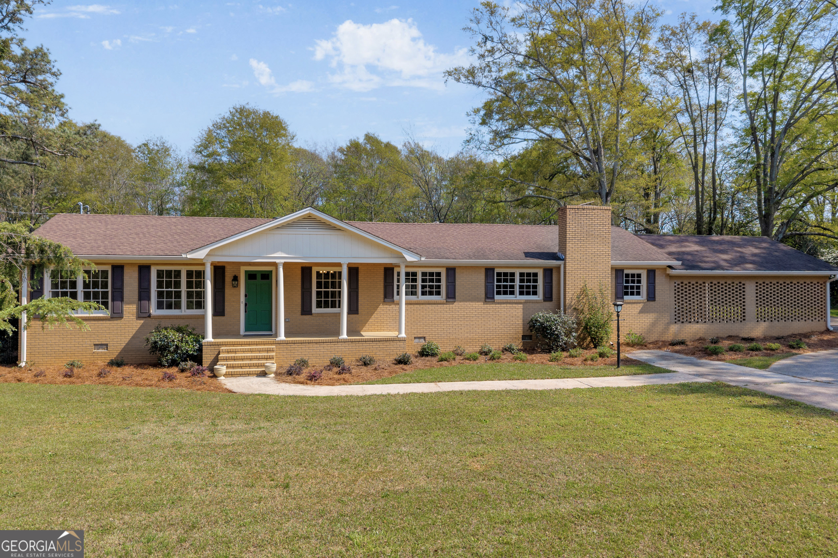 a front view of a house with yard porch and furniture