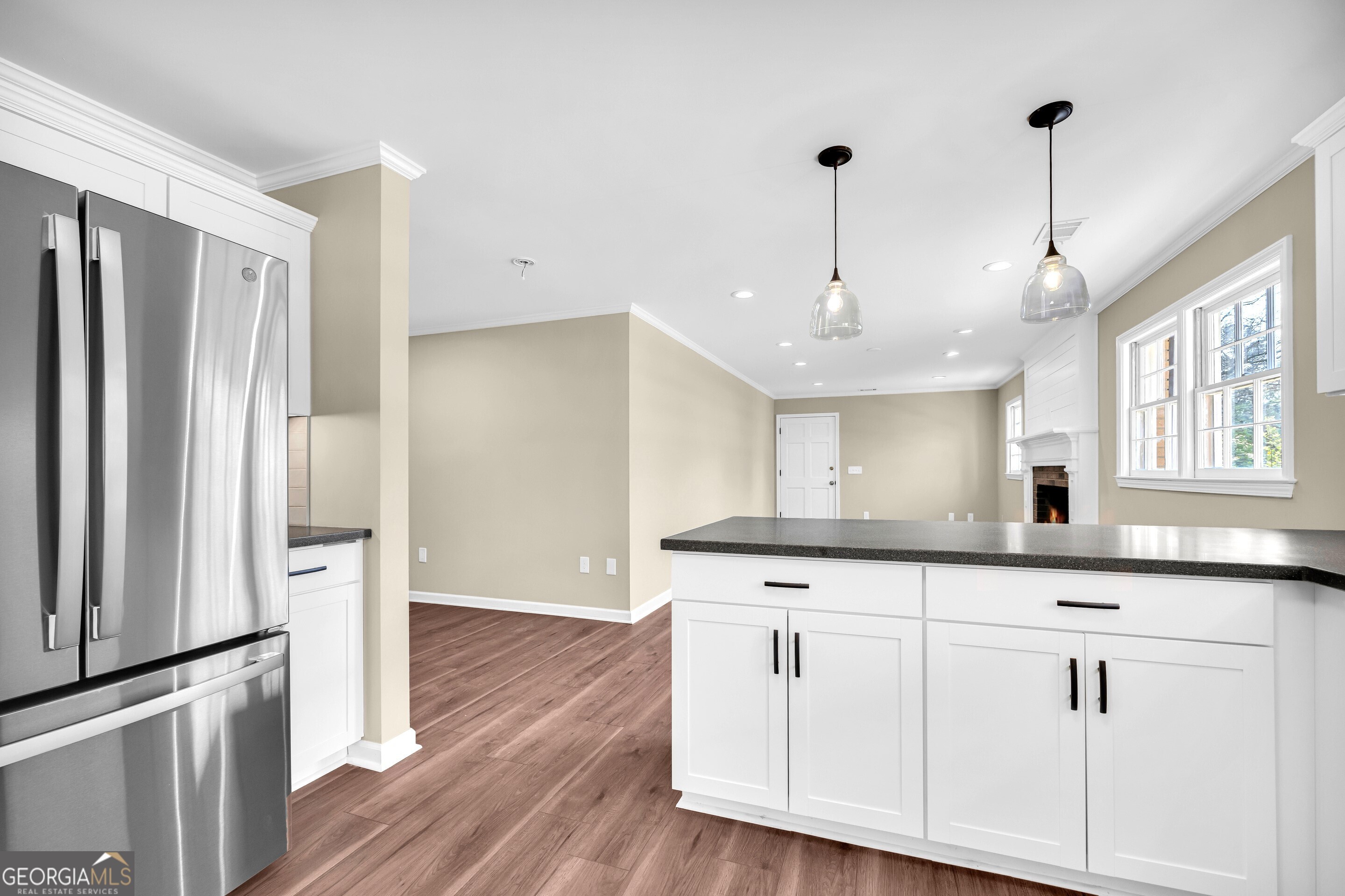 100 Broad Street Bowman, GA 30624 - Photo 16 of 65 a kitchen with granite countertop a sink a center island stainless steel appliances and cabinets