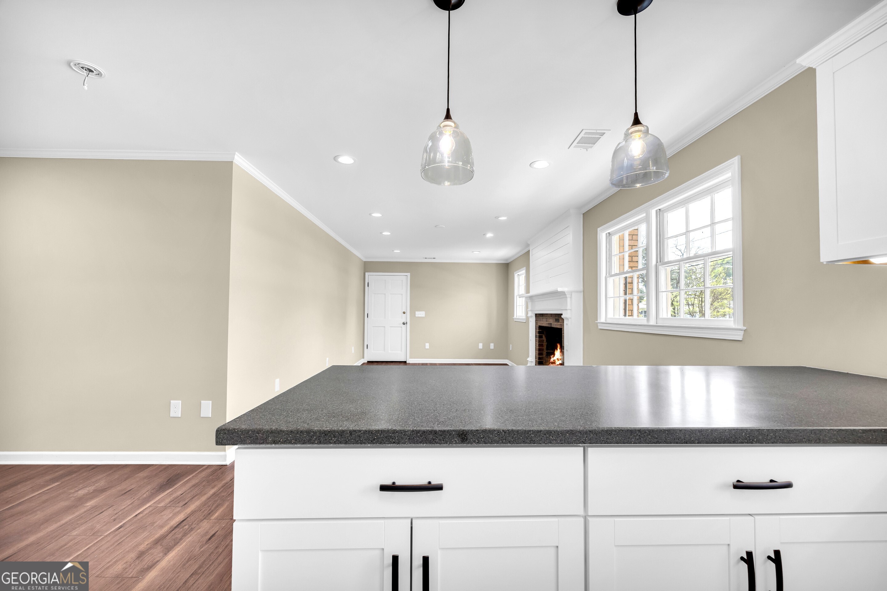 100 Broad Street Bowman, GA 30624 - Photo 17 of 65 a kitchen with kitchen island a large counter top a stove and a window