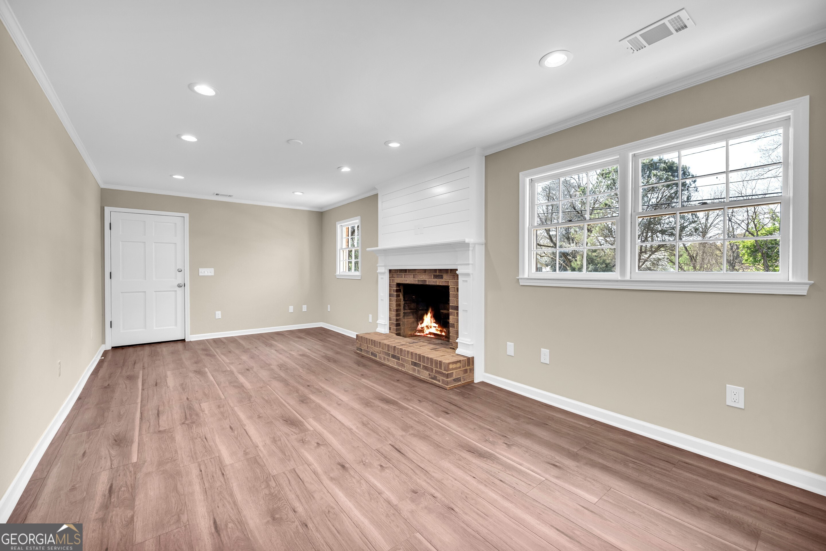 100 Broad Street Bowman, GA 30624 - Photo 18 of 65 an empty room with windows and a fireplace
