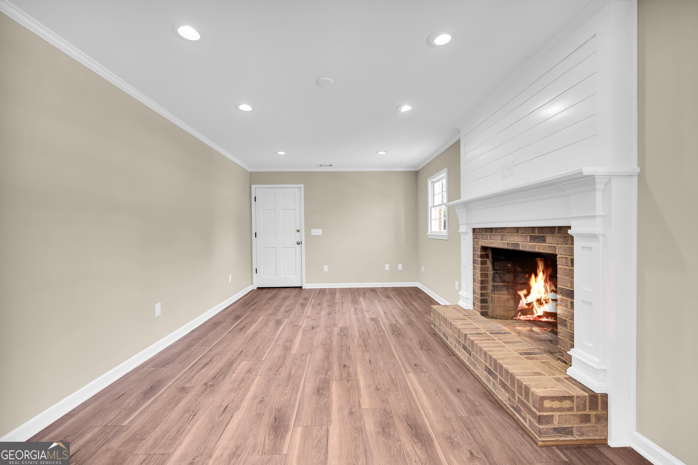 100 Broad Street Bowman, GA 30624 - Photo 19 of 65 a view of a hallway with wooden floor and a fireplace