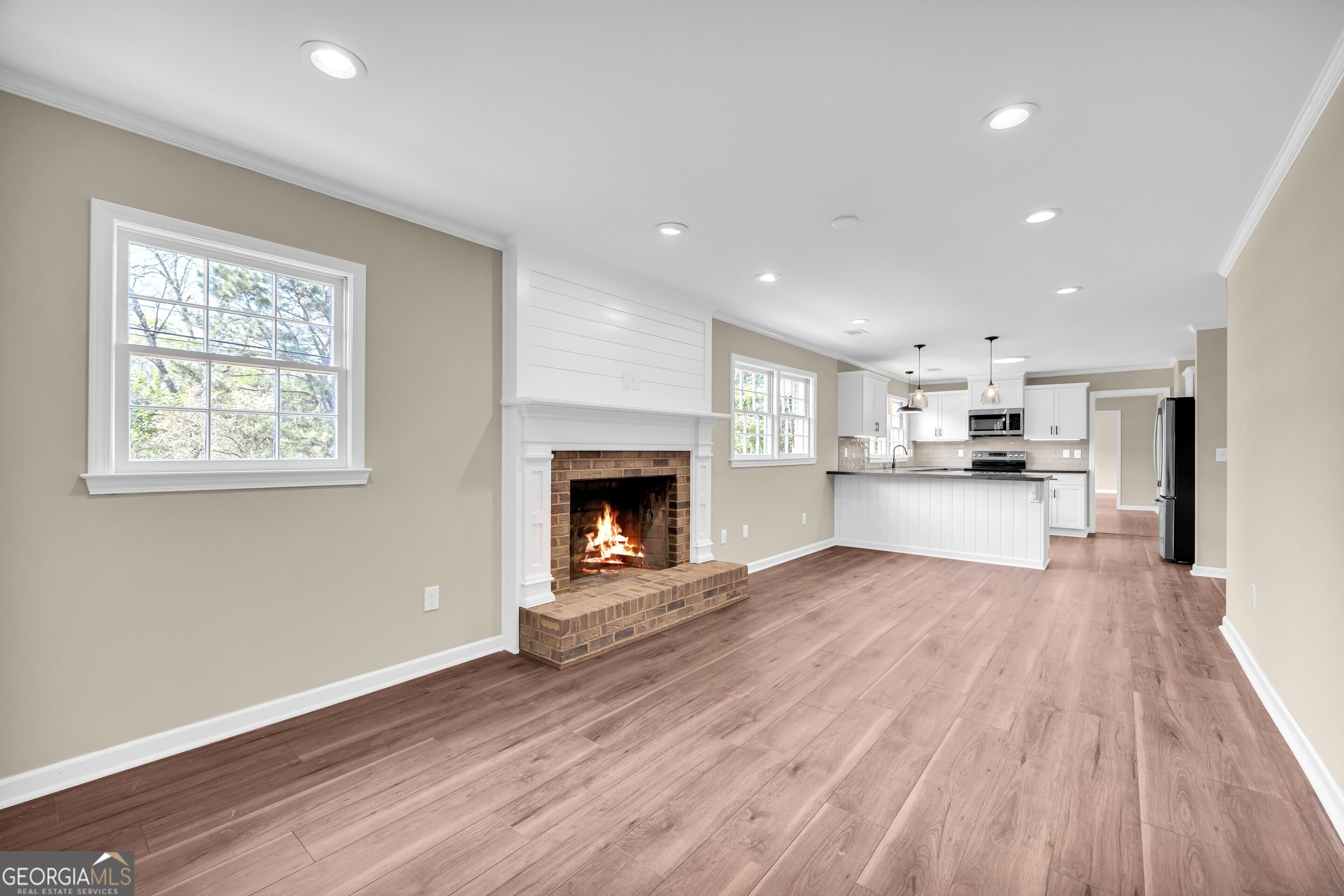 100 Broad Street Bowman, GA 30624 - Photo 21 of 65 a view of kitchen with wooden floor and a fireplace