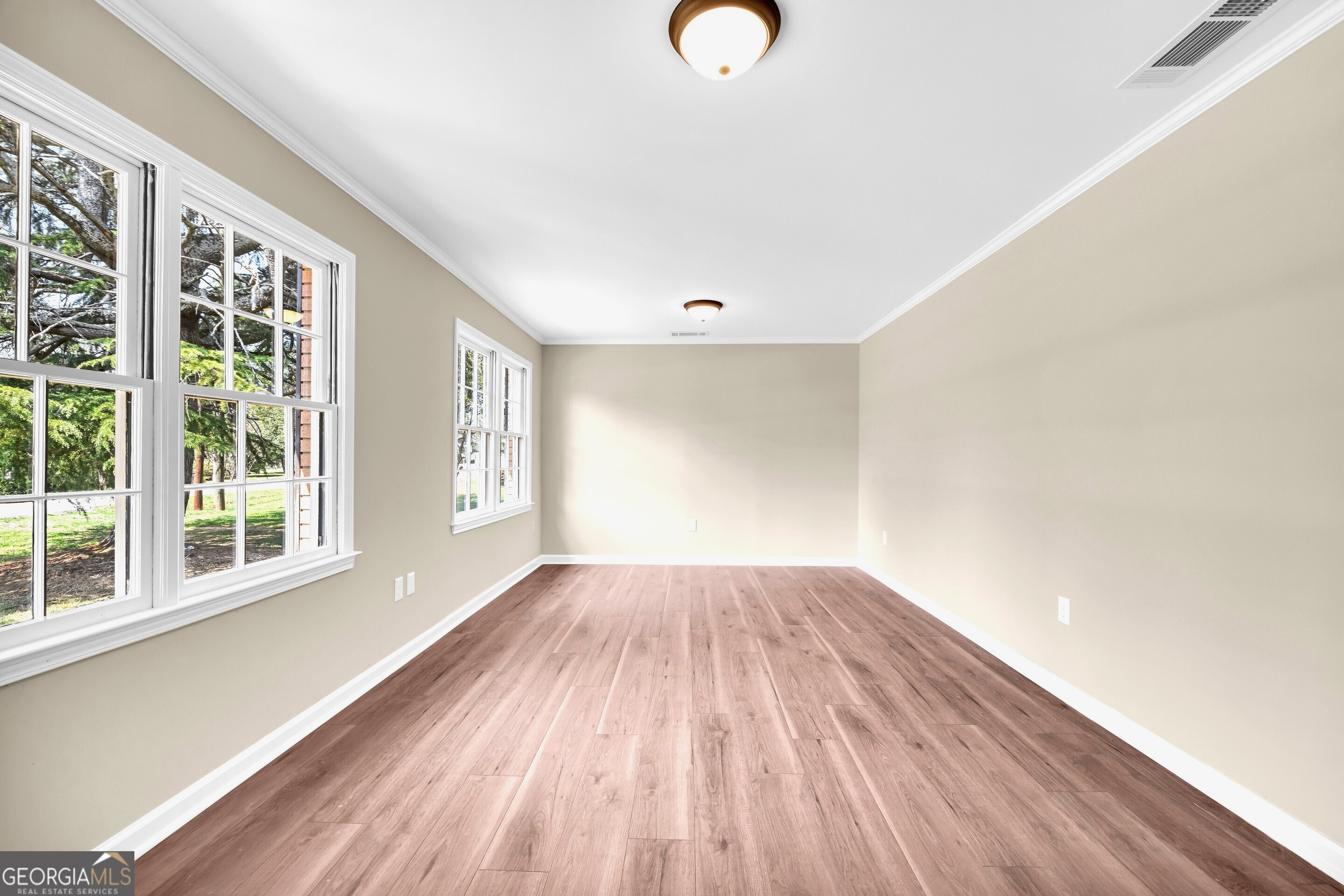 100 Broad Street Bowman, GA 30624 - Photo 24 of 65 a view of empty room with wooden floor and fan