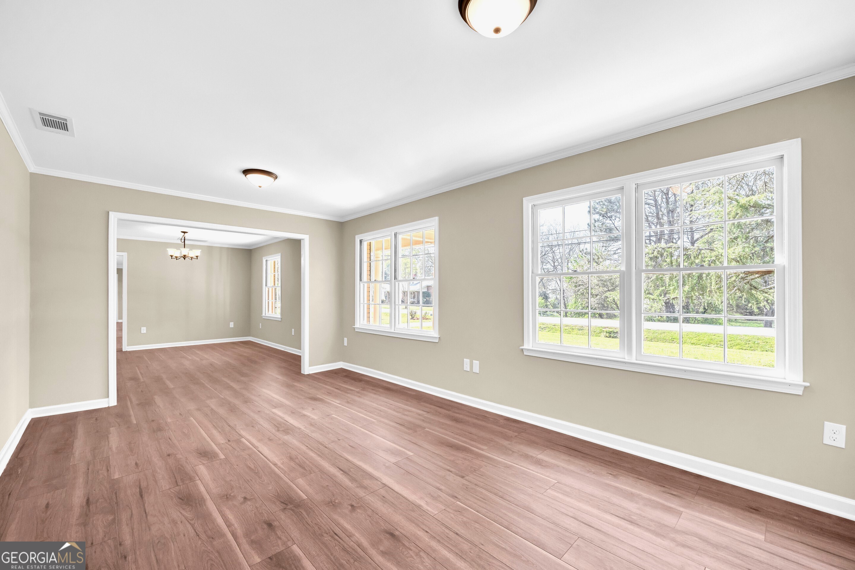 100 Broad Street Bowman, GA 30624 - Photo 25 of 65 a view of an empty room with wooden floor and a window