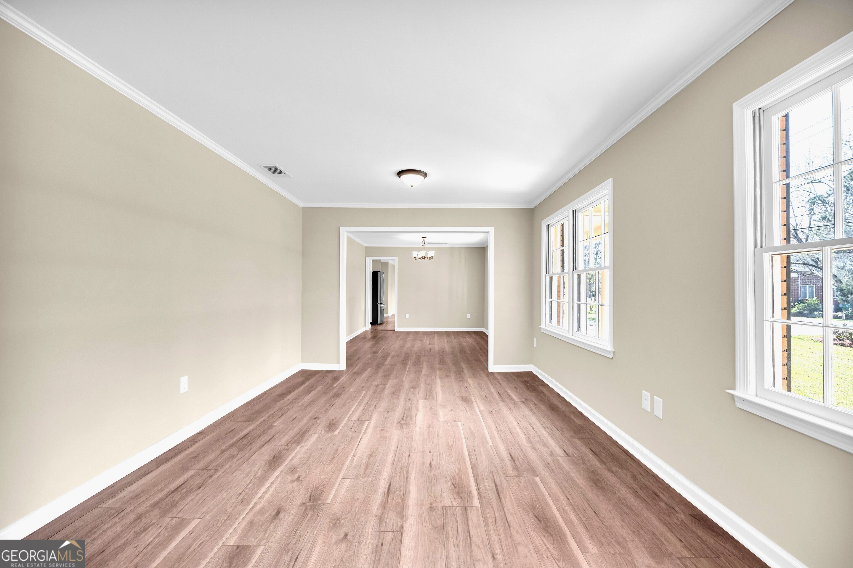 100 Broad Street Bowman, GA 30624 - Photo 26 of 65 a view of an empty room with wooden floor and a window