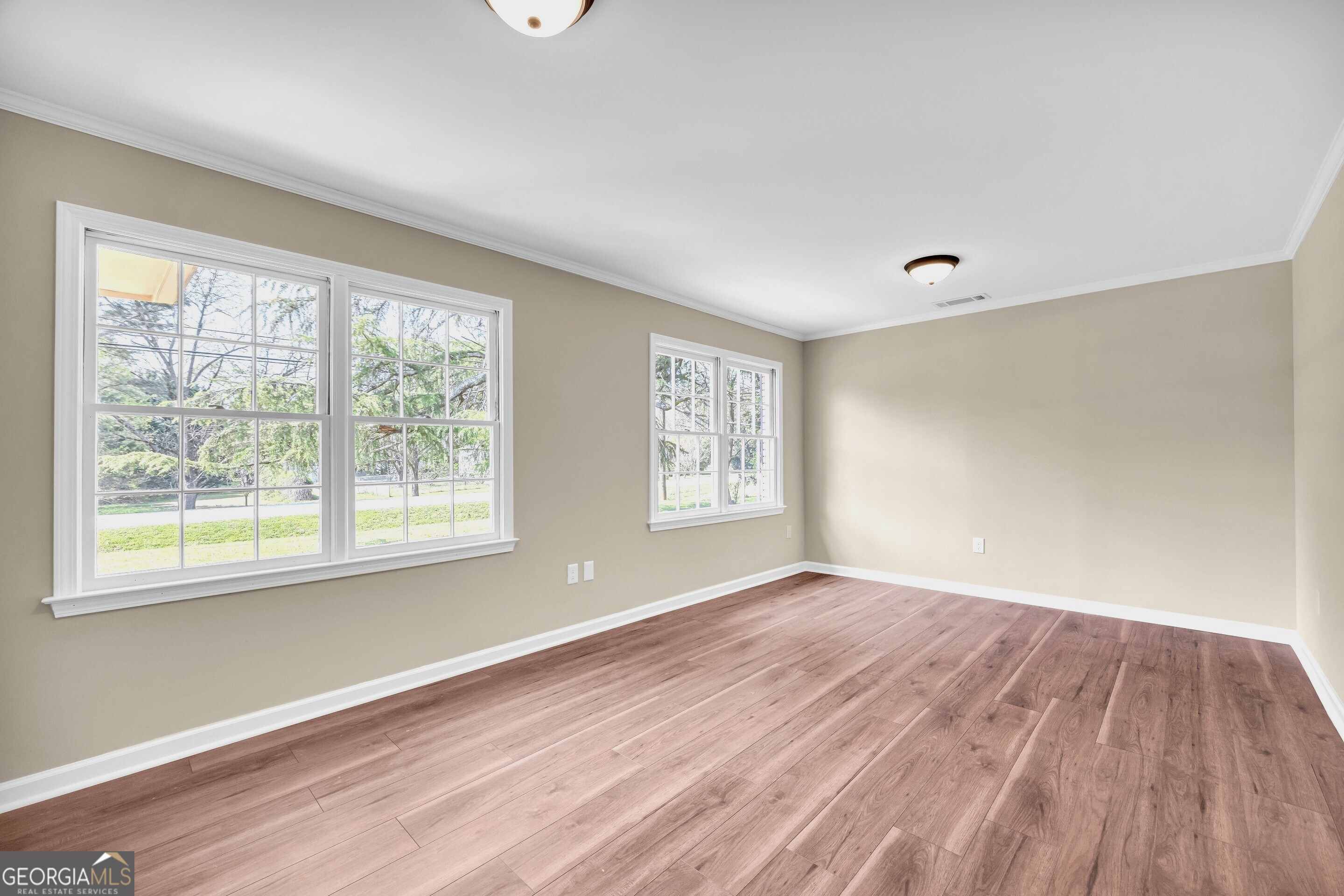 100 Broad Street Bowman, GA 30624 - Photo 27 of 65 an empty room with wooden floor and windows