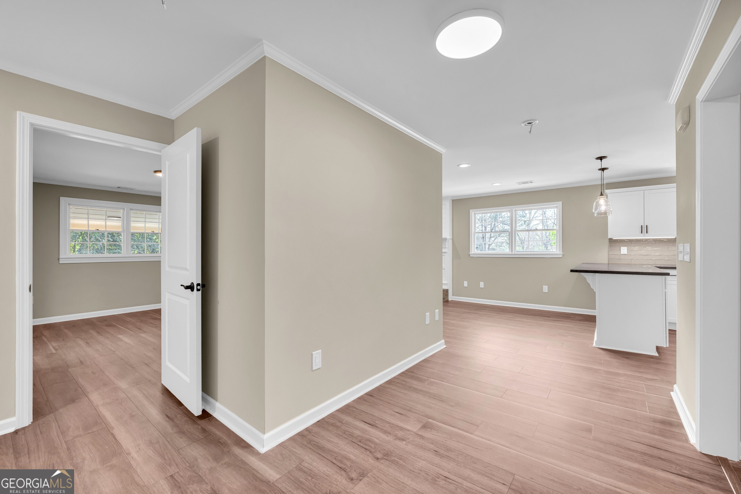 100 Broad Street Bowman, GA 30624 - Photo 29 of 65 an empty room with wooden floor and windows