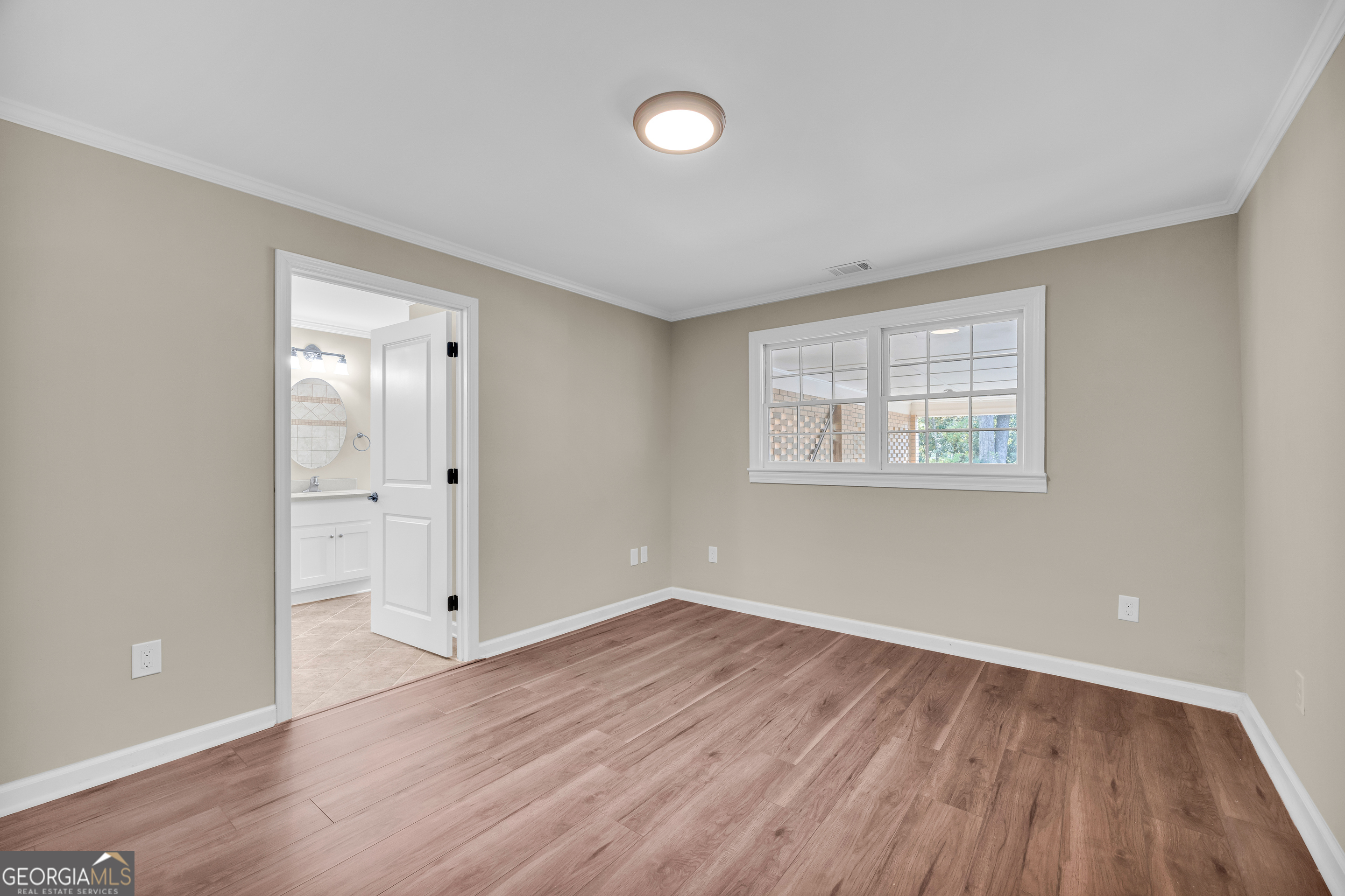 100 Broad Street Bowman, GA 30624 - Photo 30 of 65 a view of an empty room with wooden floor and a window