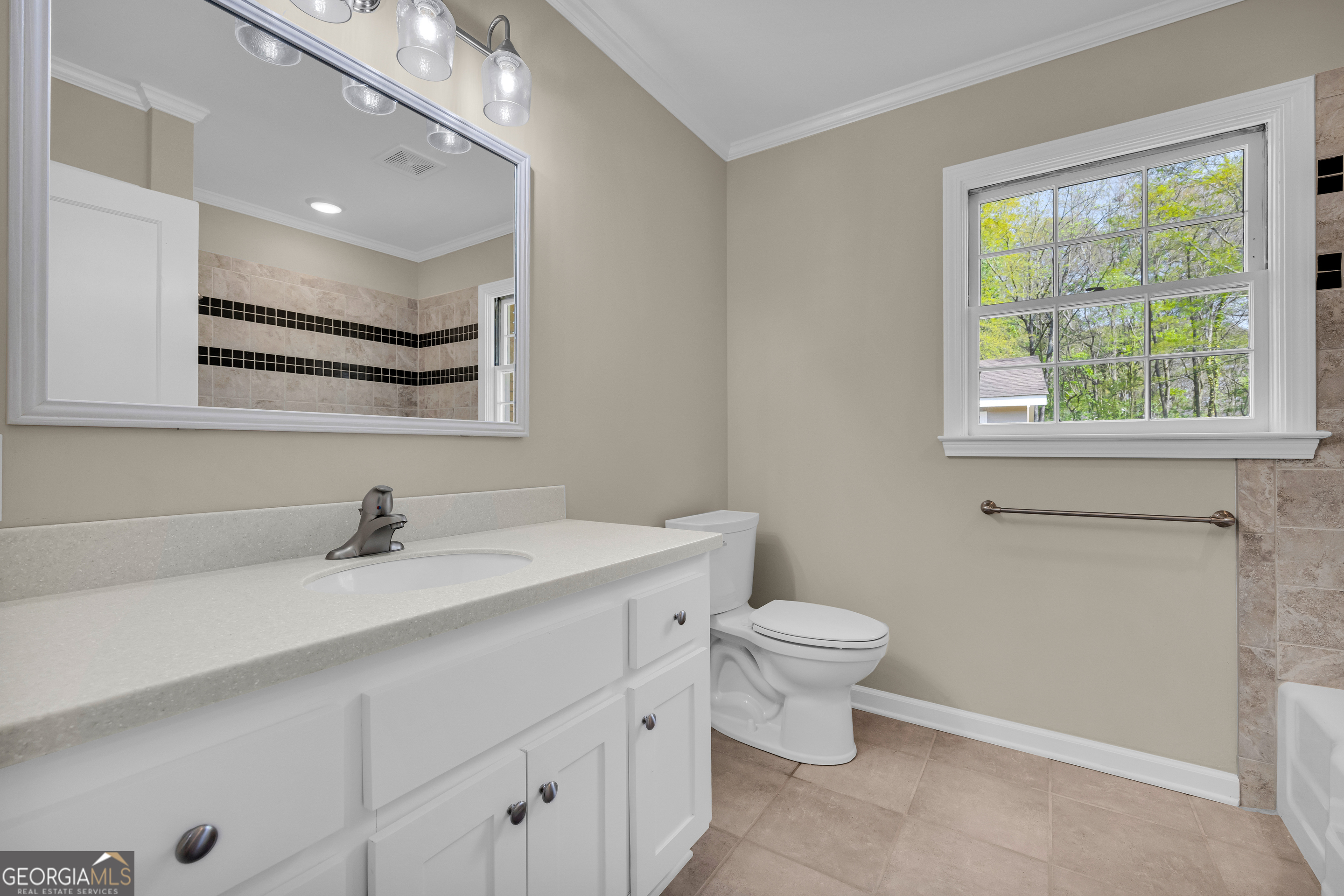 100 Broad Street Bowman, GA 30624 - Photo 40 of 65 a bathroom with a sink a toilet and a mirror
