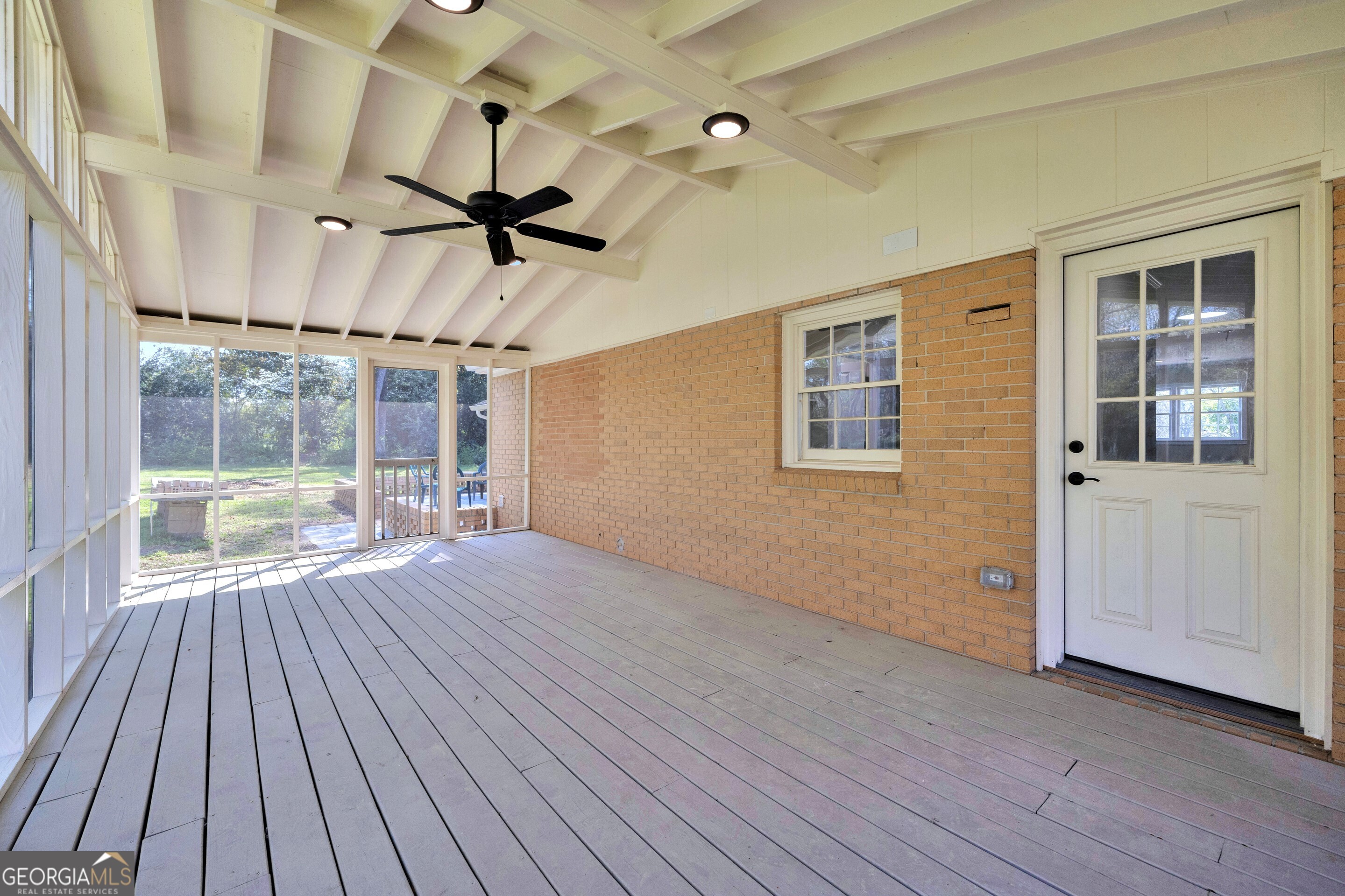 100 Broad Street Bowman, GA 30624 - Photo 44 of 65 a view of a livingroom with wooden floor and a ceiling fan