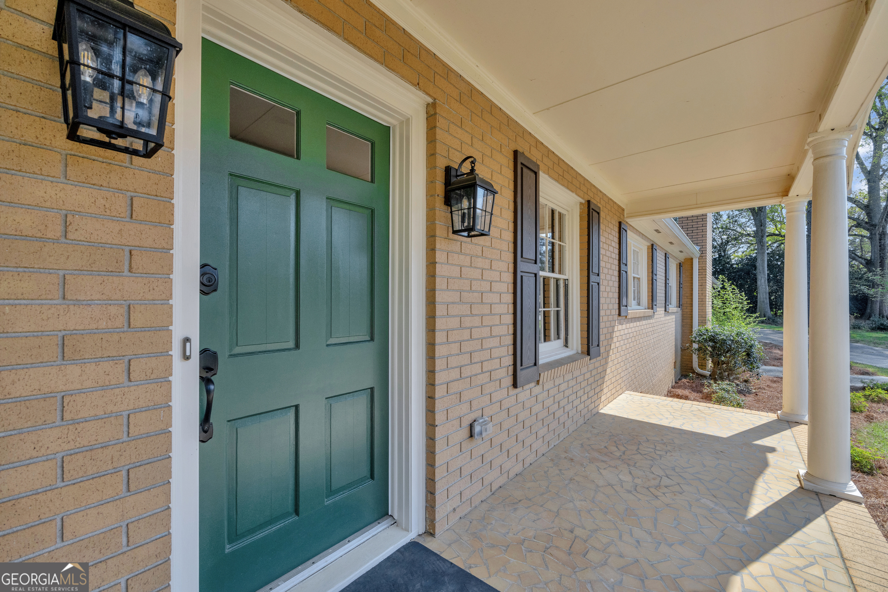 100 Broad Street Bowman, GA 30624 - Photo 5 of 65 a front view of a house with a garden