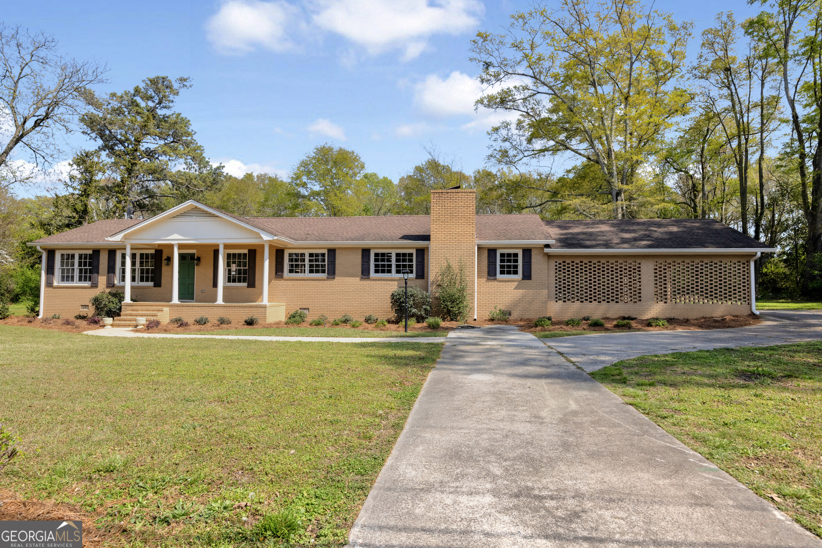 100 Broad Street Bowman, GA 30624 - Photo 52 of 65 a front view of a house with swimming pool having outdoor seating