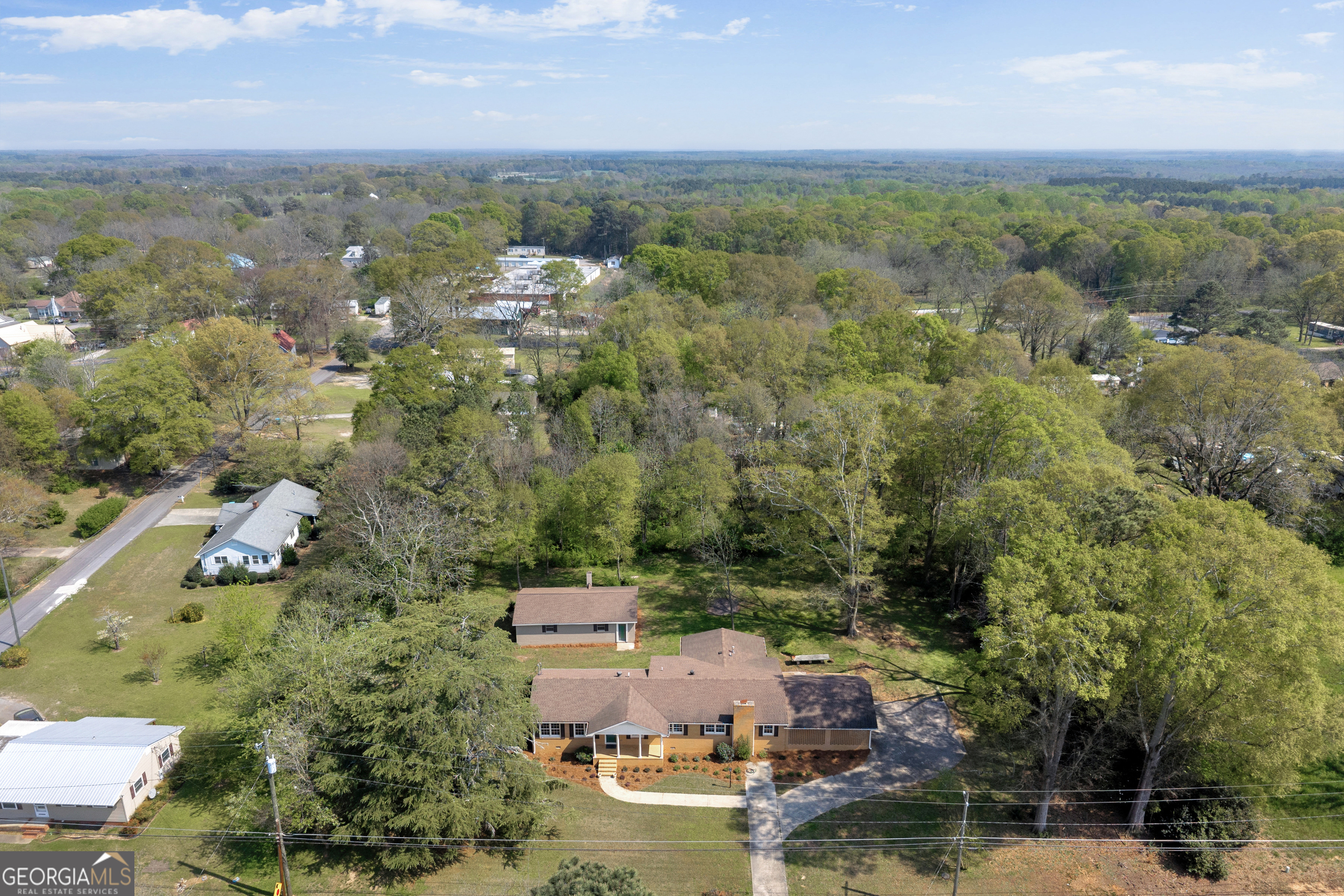 100 Broad Street Bowman, GA 30624 - Photo 58 of 65 an aerial view of a city with lots of residential buildings ocean and mountain view in back