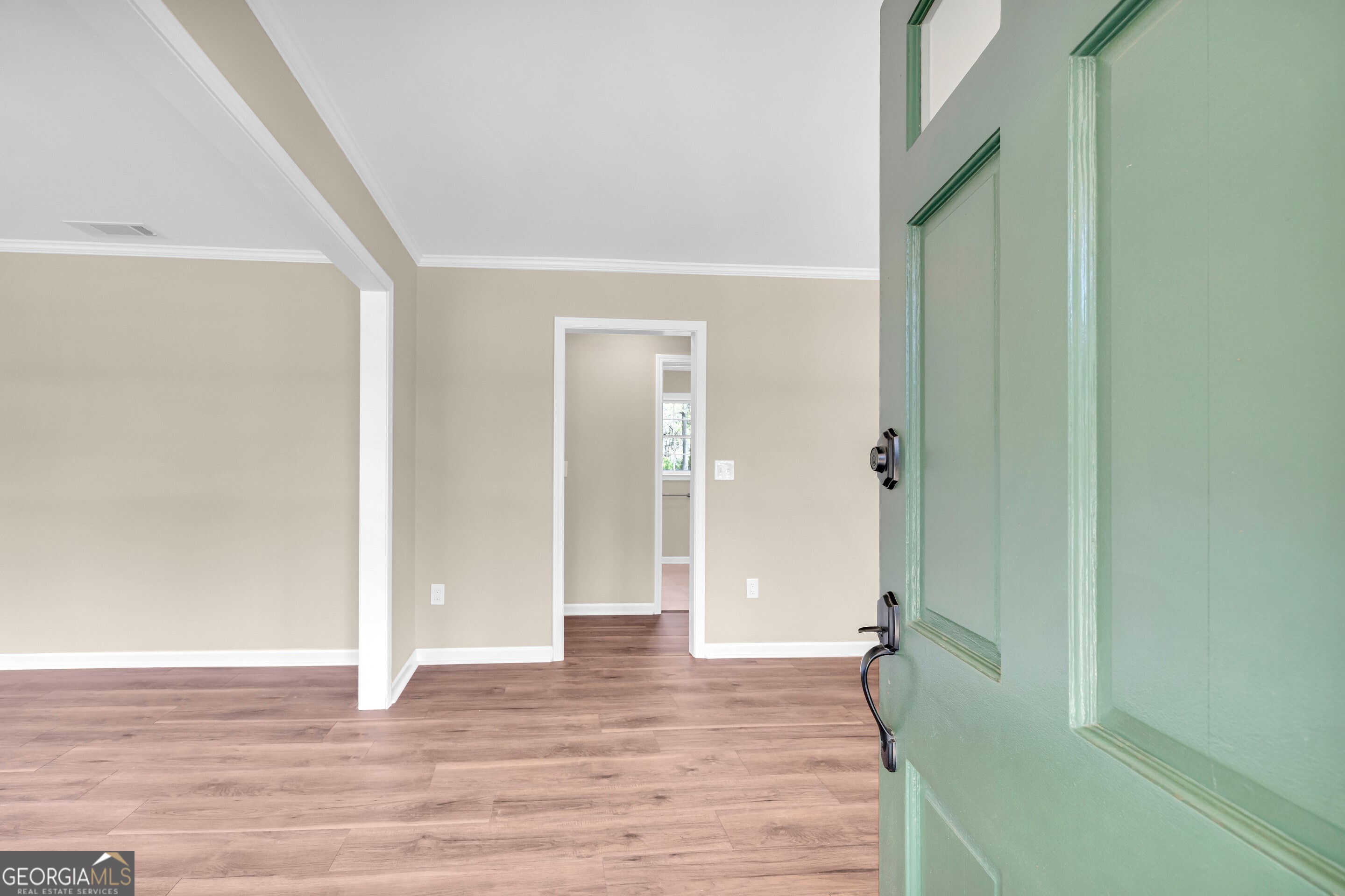 100 Broad Street Bowman, GA 30624 - Photo 6 of 65 a view of an empty room with wooden floor and a bathroom
