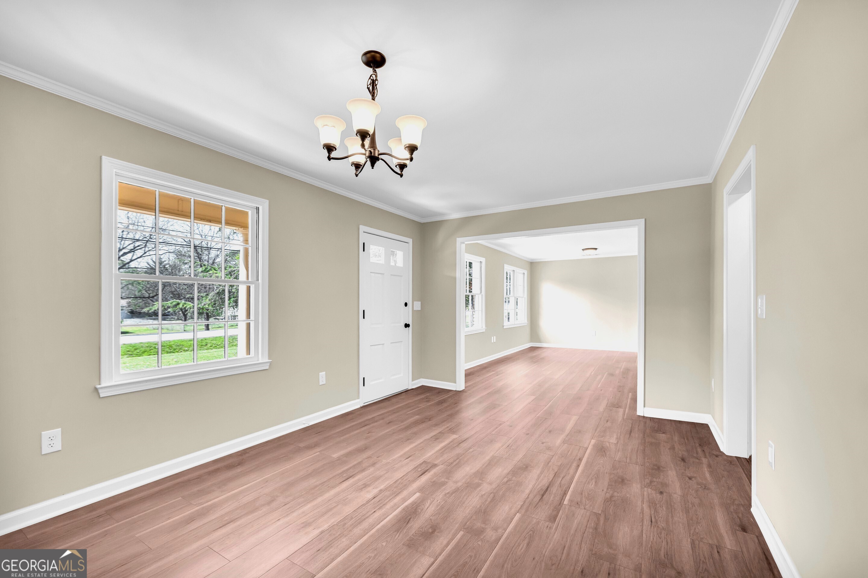 100 Broad Street Bowman, GA 30624 - Photo 8 of 65 a view of an empty room with a window and wooden floor