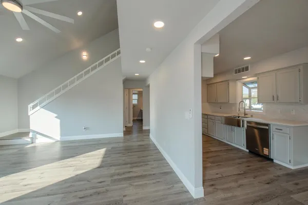 a view of kitchen with sink and wooden floor