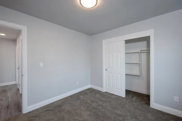 an empty room with closet area