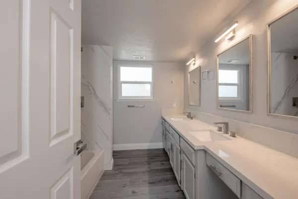 a bathroom with a double vanity sink and a mirror