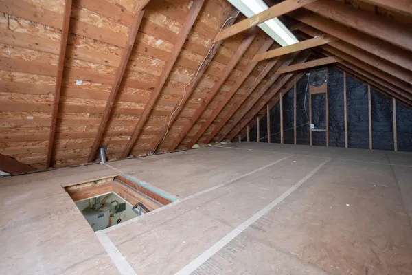 an aerial view of a house with a garden and lake view