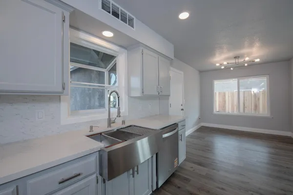 a kitchen that has a lot of cabinets in it