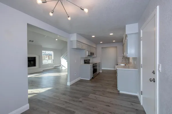 a view of kitchen with cabinets and wooden floor