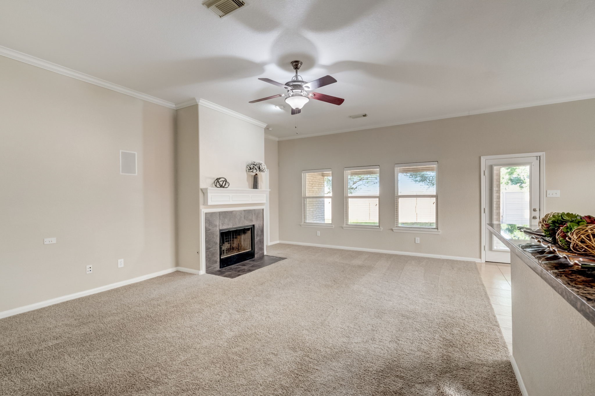 7219 Palmito Ranch Drive Richmond, TX 77406 - Photo 14 of 32 a view of a livingroom with a fireplace a ceiling fan and windows