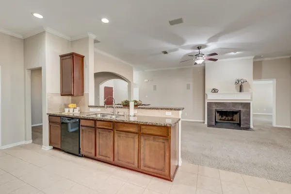 a kitchen with stainless steel appliances granite countertop a sink stove and cabinets