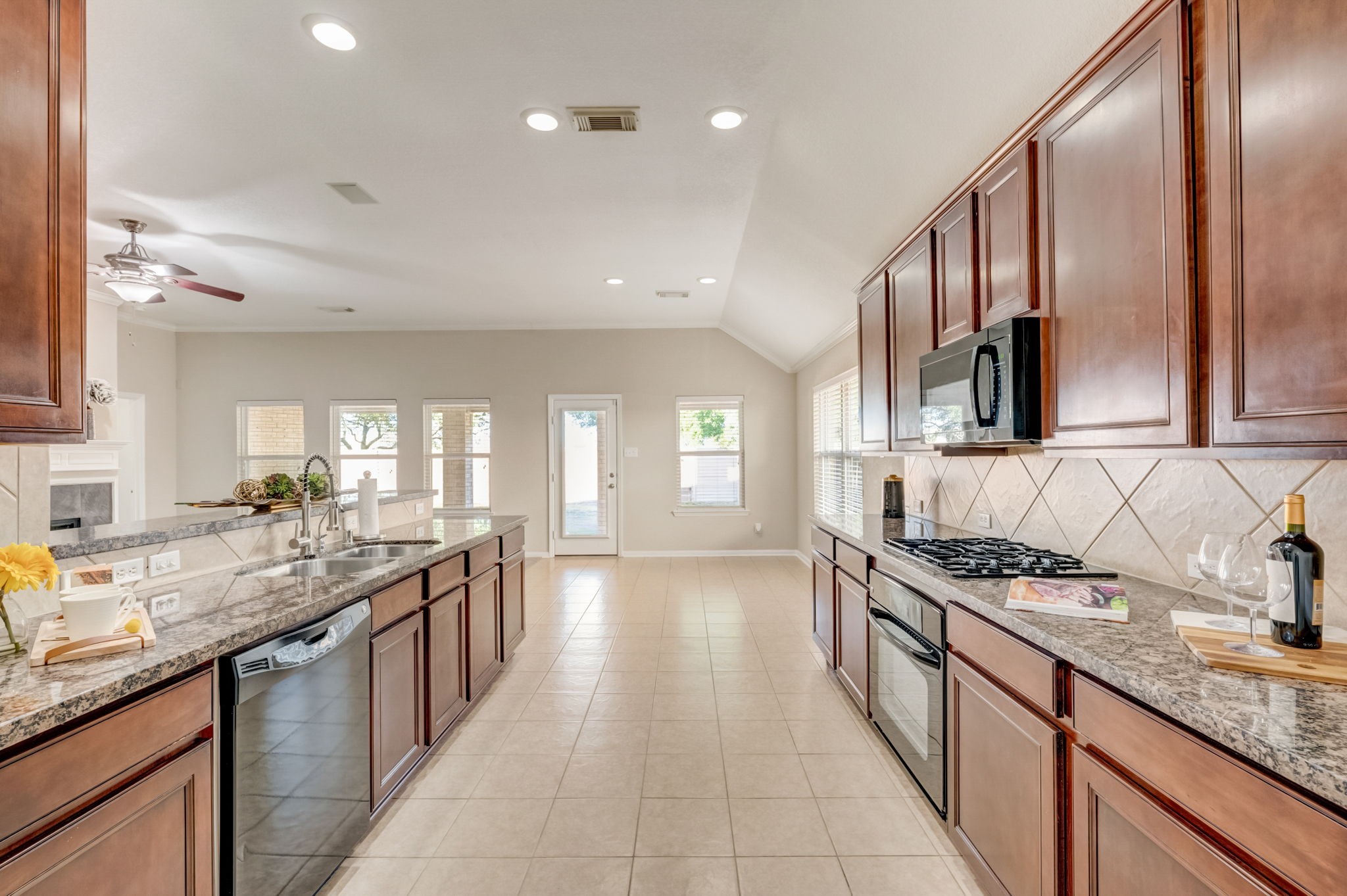 7219 Palmito Ranch Drive Richmond, TX 77406 - Photo 19 of 32 a kitchen with stainless steel appliances granite countertop a sink stove and cabinets