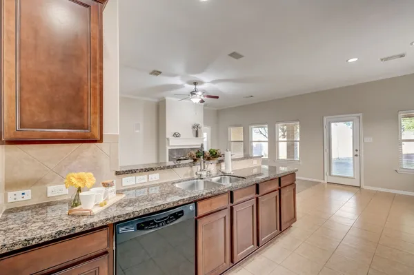 a kitchen with granite countertop a sink and a stove
