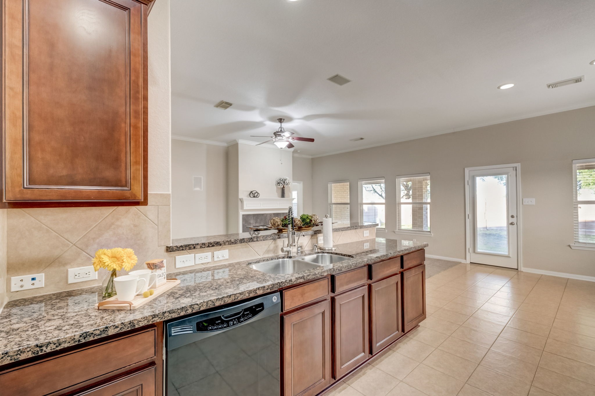 7219 Palmito Ranch Drive Richmond, TX 77406 - Photo 21 of 32 a kitchen with granite countertop a sink and white cabinets