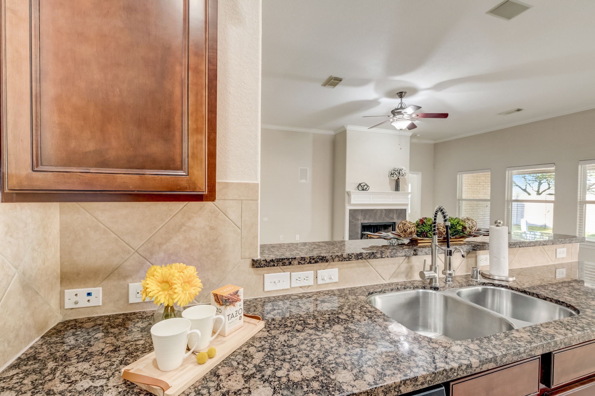 7219 Palmito Ranch Drive Richmond, TX 77406 - Photo 23 of 32 a kitchen with granite countertop a sink and a stove
