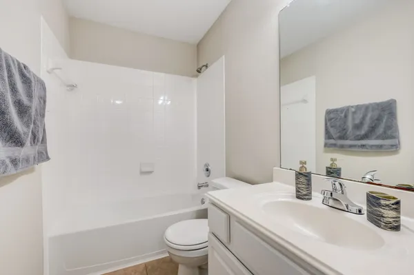 a view of a kitchen with a stove cabinets a ceiling fan and wooden floor