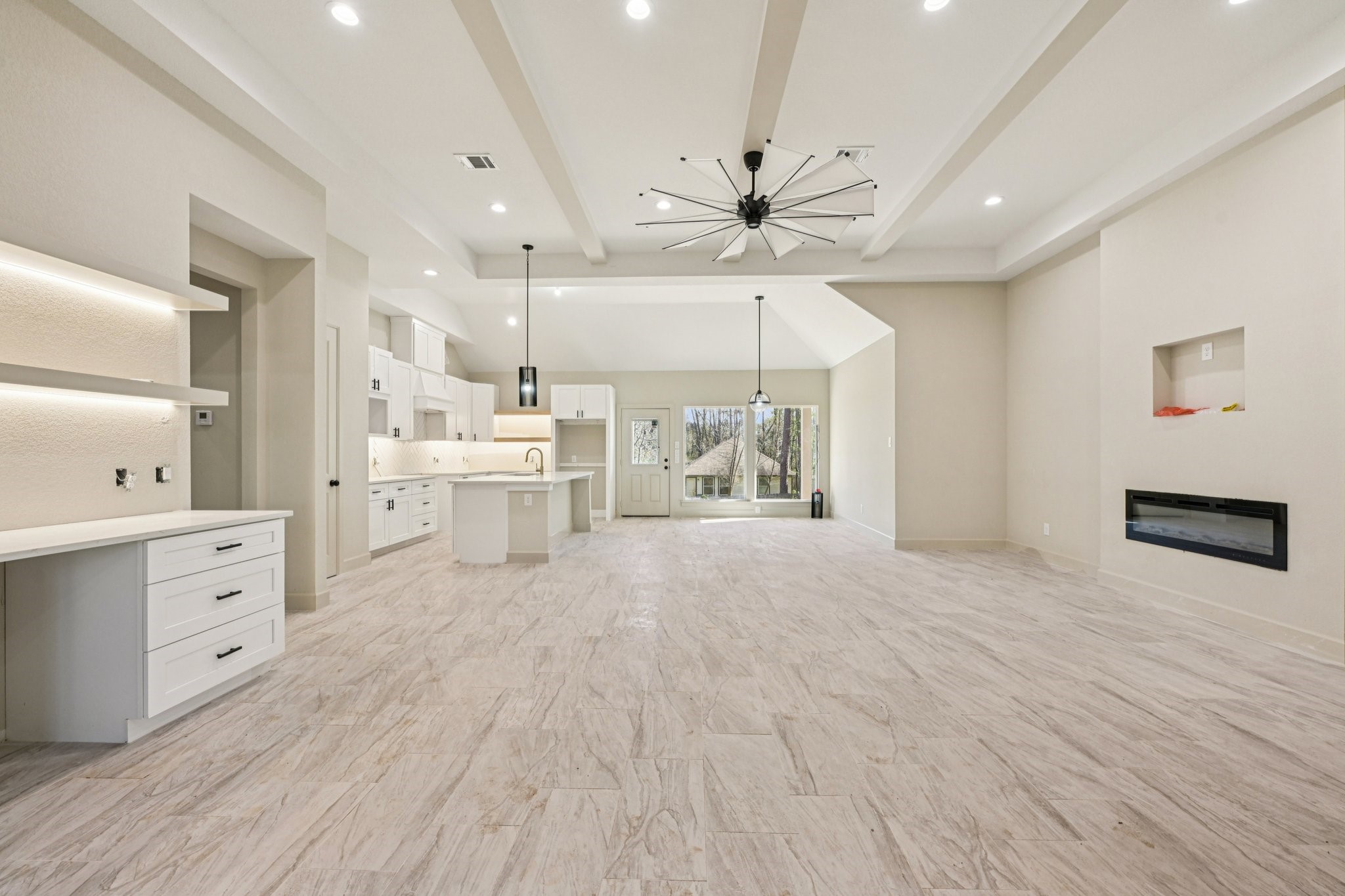 15132 Coaltown Road Willis, TX 77378 - Photo 7 of 29 From the moment you enter, warm wood finishes create an elegant feel, complemented by high ceilings and an open-concept layout that flows seamlessly into the kitchen.